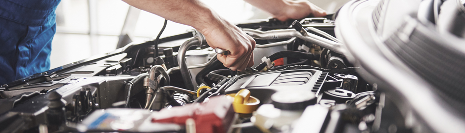 Mechanic Working On Car Engine